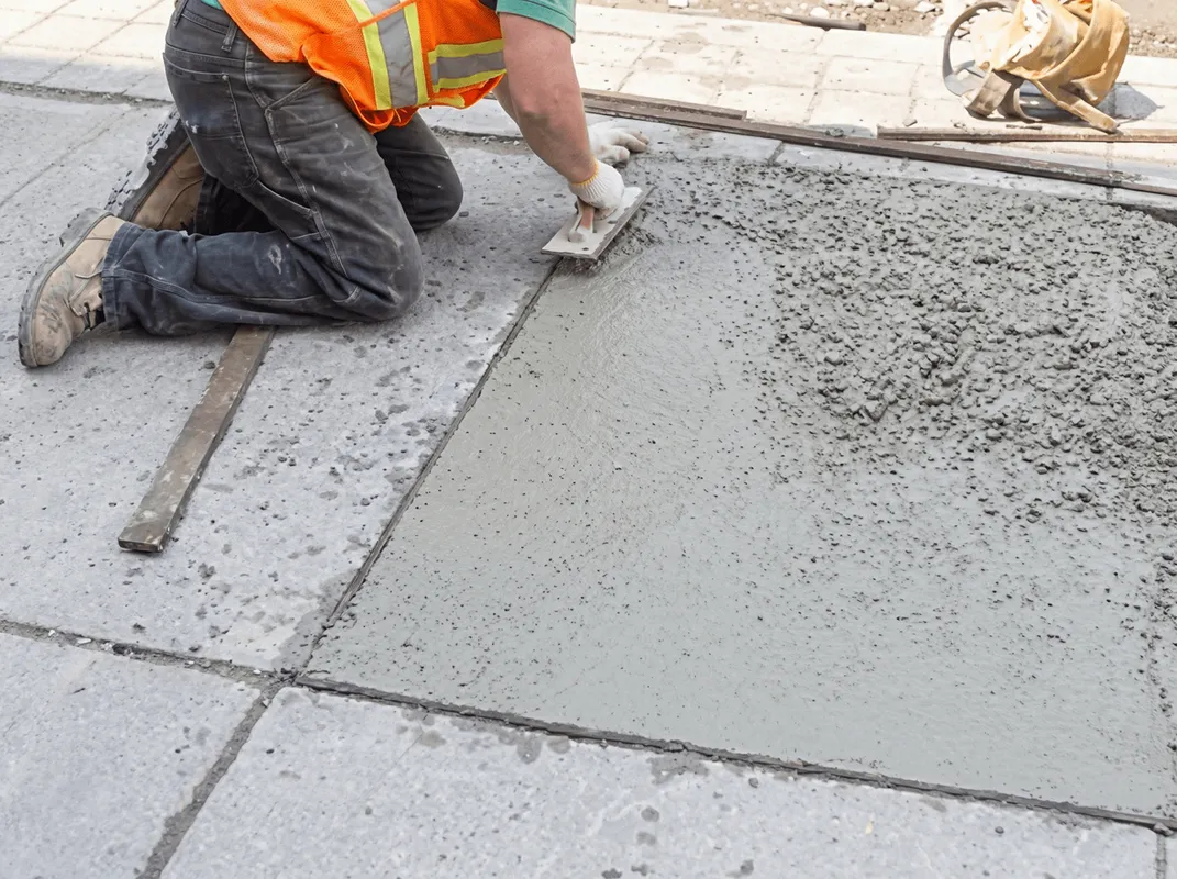 Professional repairing a concrete floor in Nashua, NH